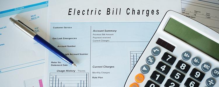 Federal State Incentives Electric Bill Charges in Paper with Calculator and Pen
